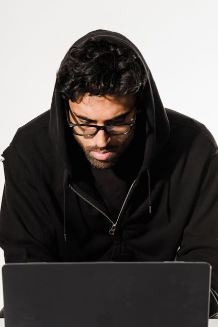 Analyst reviewing security indicators on a laptop with logs and system alerts