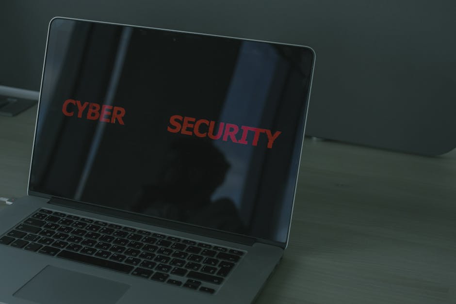 Technician reviewing hacked website code and security steps on a laptop