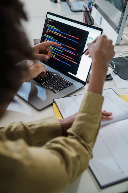 Developer reviewing suspicious code on a computer during malware cleanup