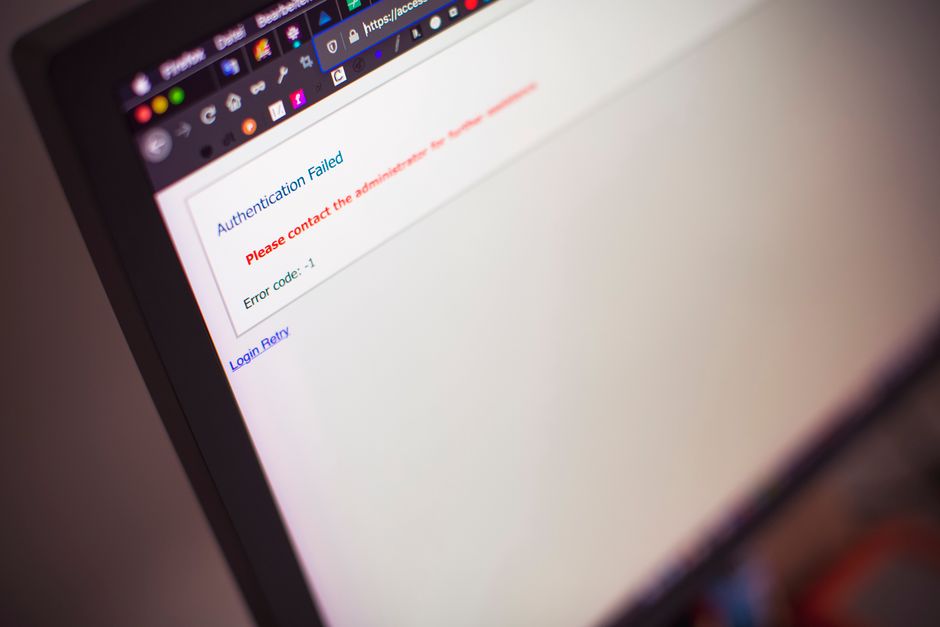 Laptop with login screen and security alerts showing blocked repeated sign-in attempts