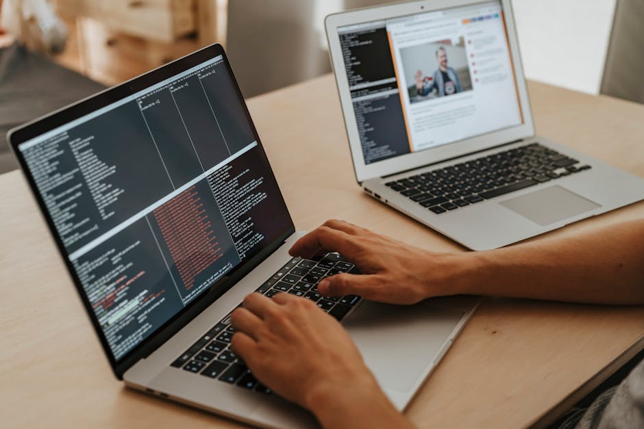 Web admin reviewing server config changes on a laptop during malware cleanup