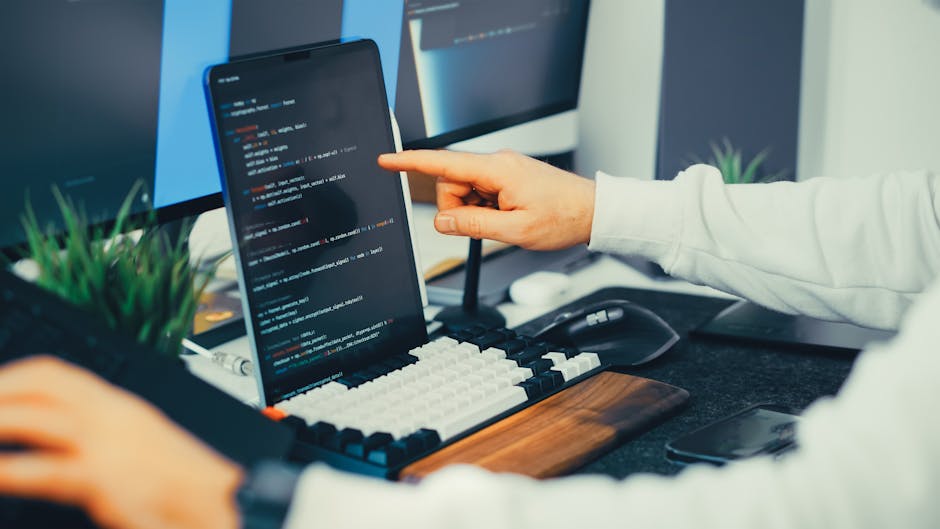 Person reviewing staging website on screen to verify login, pages, and form functionality.